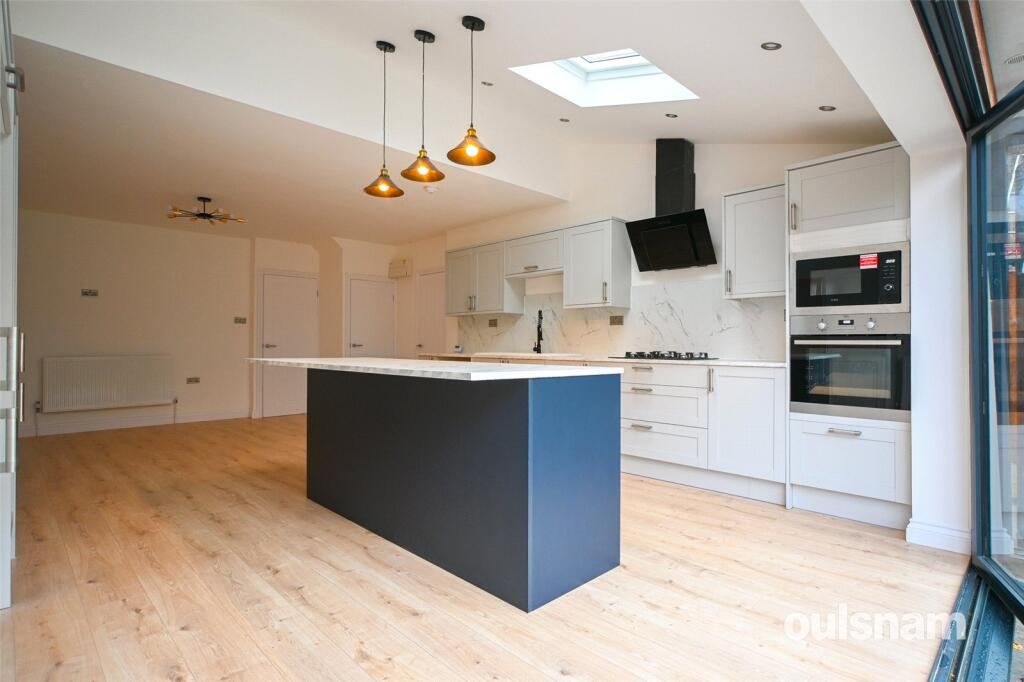 Completed open-plan kitchen with navy island